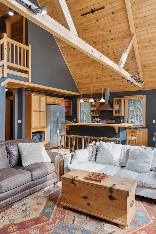 living area featuring wooden ceiling and lofted ceiling with beams