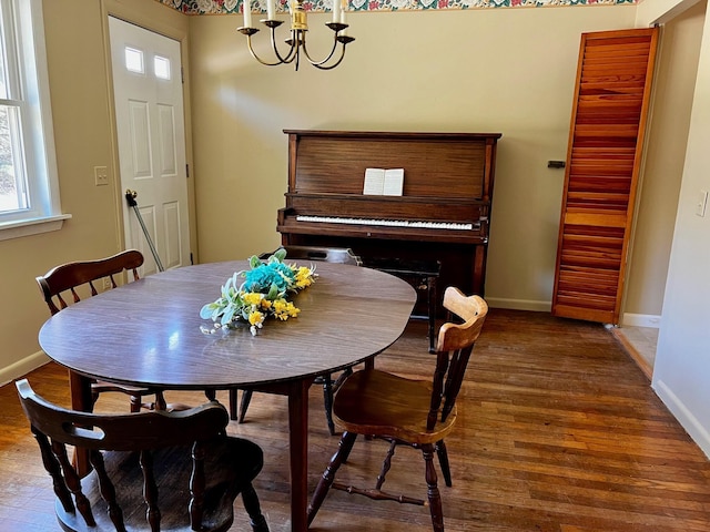 dining area with dark wood-type flooring and baseboards