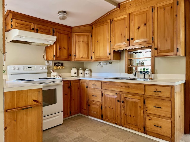 kitchen with white range with electric cooktop, light countertops, brown cabinetry, a sink, and under cabinet range hood