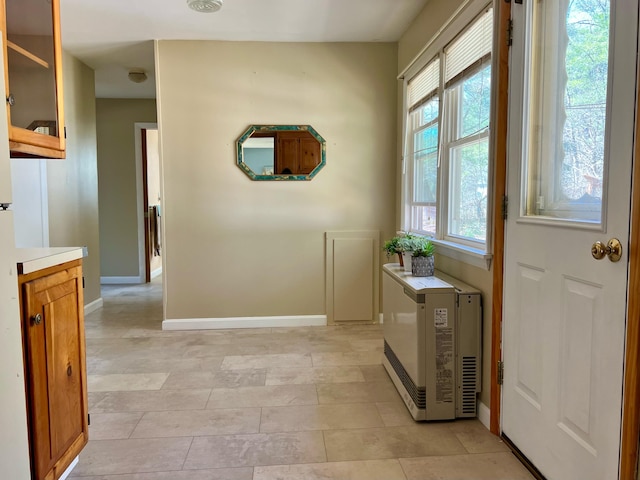 doorway to outside featuring plenty of natural light and baseboards