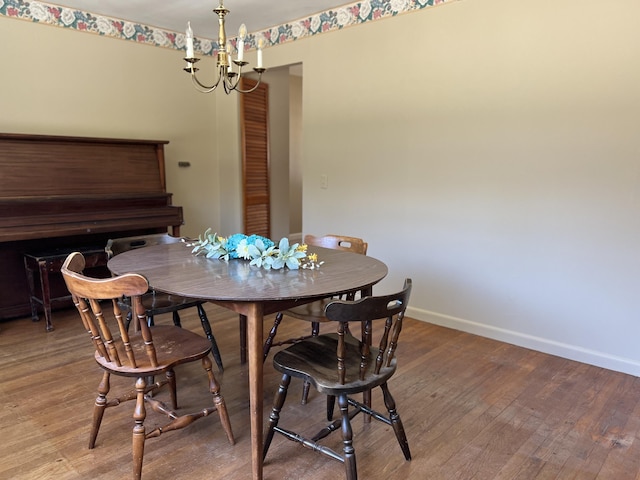 dining room with an inviting chandelier, wood finished floors, and baseboards