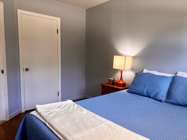 bedroom featuring dark wood finished floors and baseboards