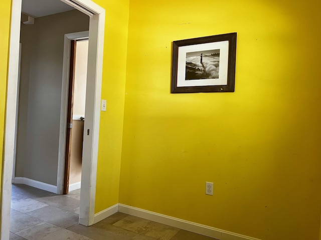 hallway featuring baseboards