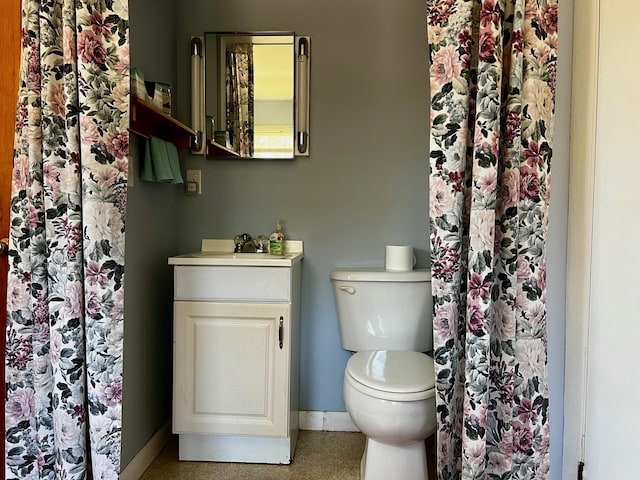 bathroom featuring toilet and baseboards