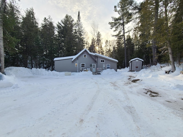 view of front facade with a storage shed, an outdoor structure, and a garage