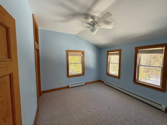 empty room with light carpet, vaulted ceiling, baseboards, and baseboard heating