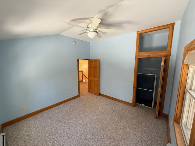 unfurnished bedroom featuring lofted ceiling, ceiling fan, light carpet, and baseboards