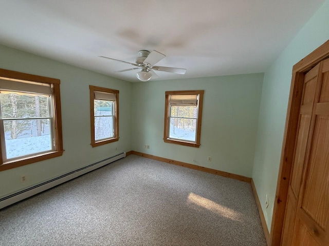 unfurnished bedroom with carpet floors, ceiling fan, baseboards, and baseboard heating