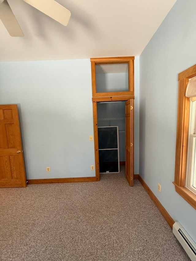 unfurnished living room featuring ceiling fan, carpet, baseboards, and baseboard heating