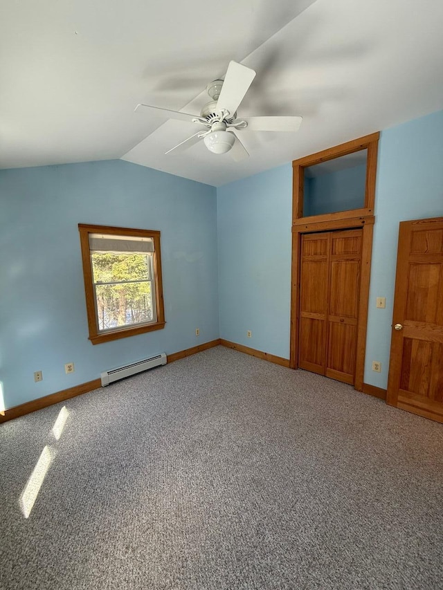 unfurnished bedroom with lofted ceiling, a baseboard radiator, baseboards, and carpet flooring