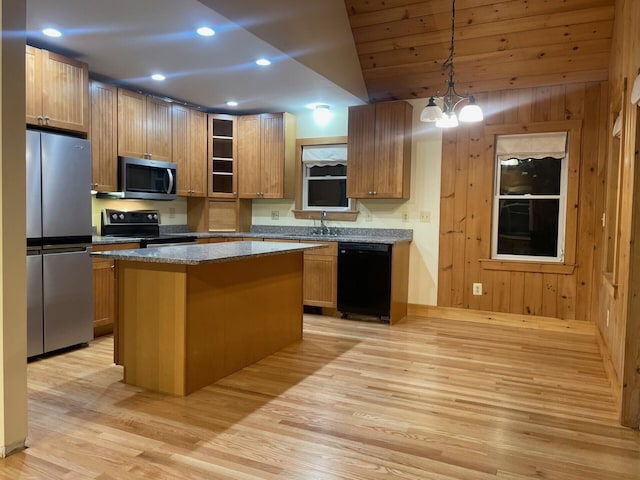 kitchen featuring glass insert cabinets, a center island, stainless steel appliances, pendant lighting, and a notable chandelier