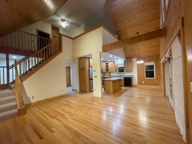 unfurnished living room with light wood-type flooring, wooden ceiling, stairway, and ceiling fan with notable chandelier