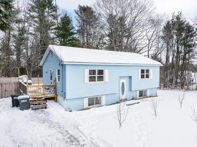 split foyer home with a chimney and a deck