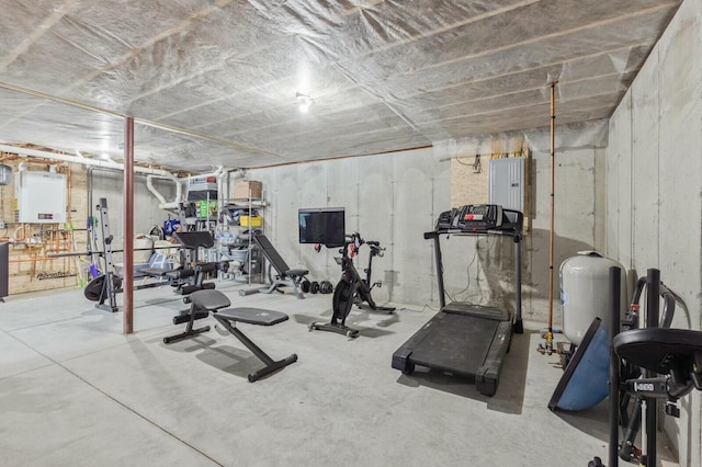 workout room with water heater and electric panel