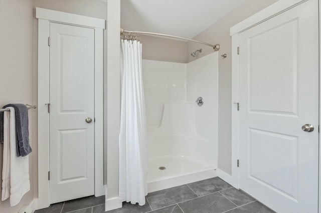 bathroom with a shower with curtain and tile patterned floors