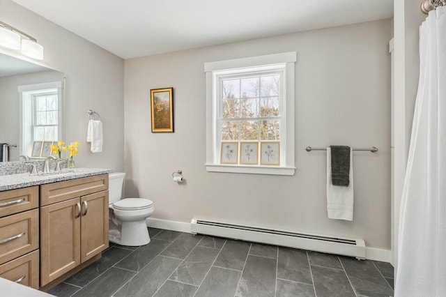 full bathroom featuring baseboards, toilet, a baseboard radiator, tile patterned floors, and vanity