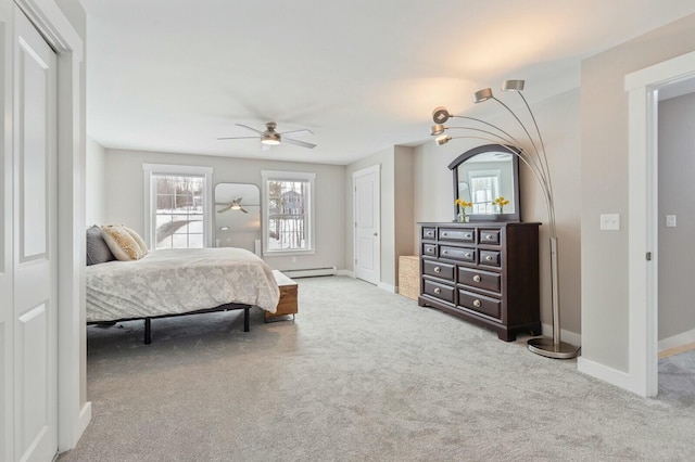 carpeted bedroom with a baseboard radiator, baseboards, and a ceiling fan