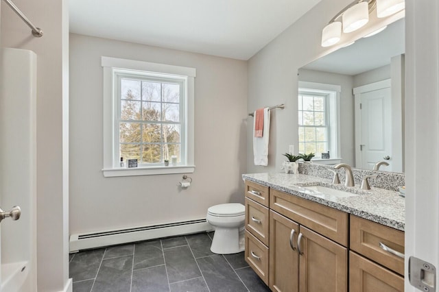 bathroom with a shower, toilet, tile patterned flooring, vanity, and a baseboard heating unit