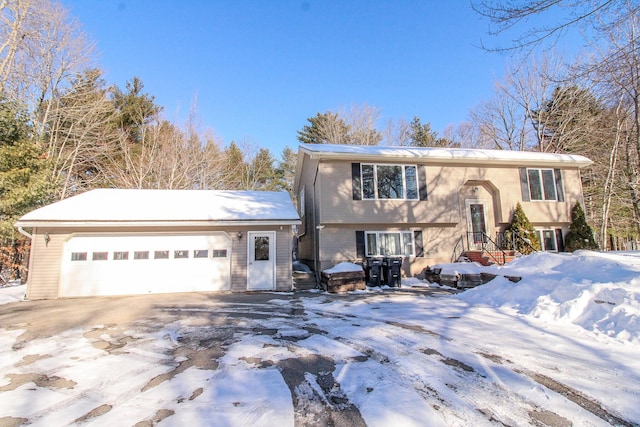 split foyer home with an attached garage and driveway