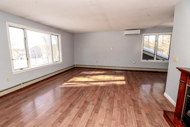 empty room with a wall mounted AC, a fireplace, wood finished floors, and a baseboard radiator