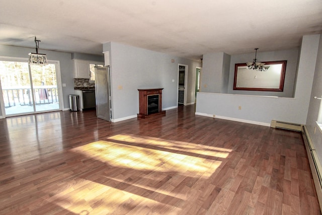 unfurnished living room featuring a chandelier, a baseboard radiator, dark wood-style flooring, and a fireplace