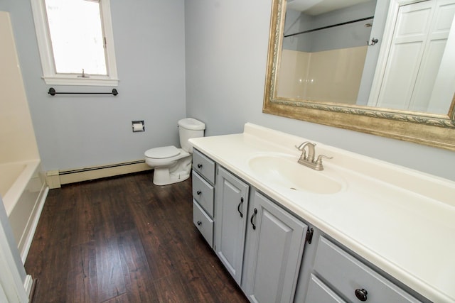 full bath with toilet, baseboard heating, wood finished floors, and vanity