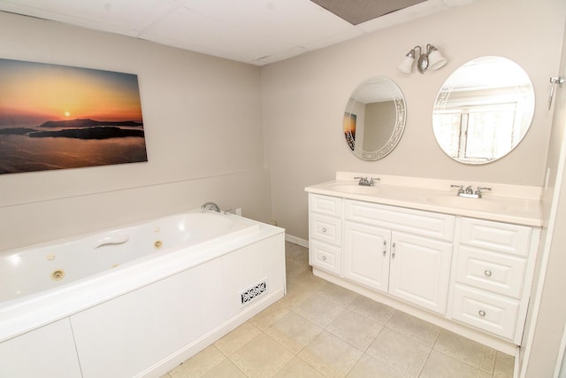 full bathroom with a whirlpool tub, a drop ceiling, a sink, and tile patterned flooring