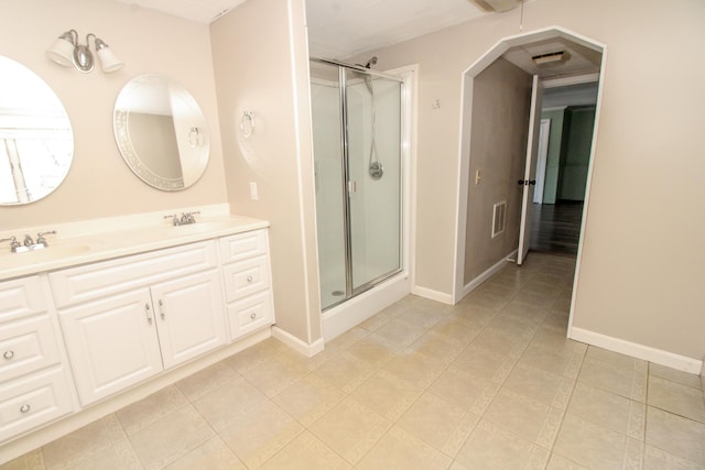 full bathroom featuring a sink, visible vents, baseboards, double vanity, and a stall shower