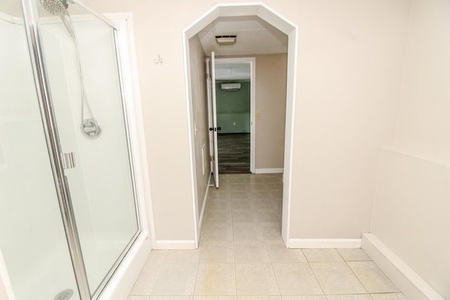 full bathroom with a wall unit AC, visible vents, baseboards, tile patterned floors, and a stall shower