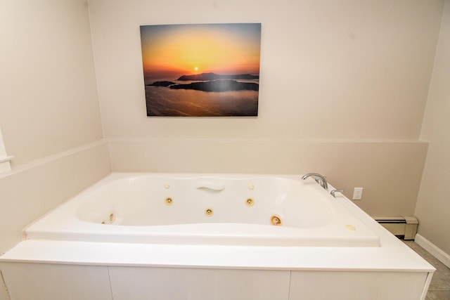 full bath featuring a baseboard radiator, a tub with jets, and baseboards