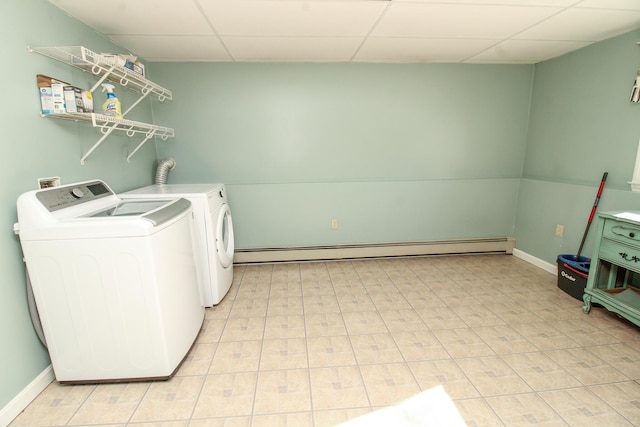 laundry area with laundry area, baseboards, a baseboard heating unit, and washer and dryer