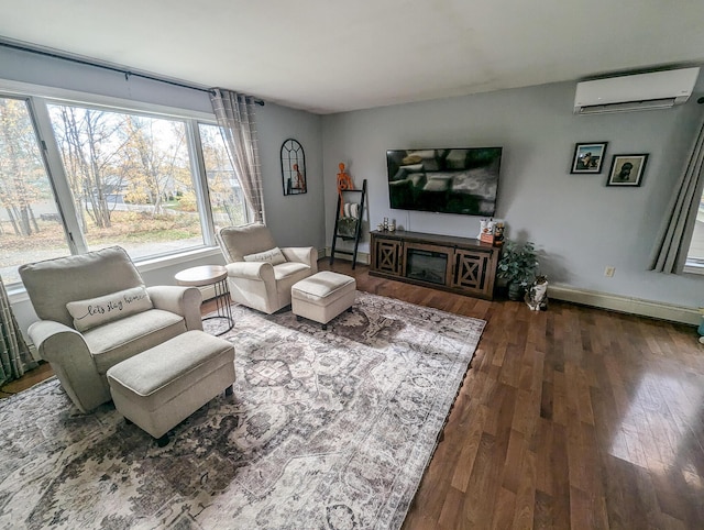 living area featuring dark wood-type flooring, a wall unit AC, and baseboards