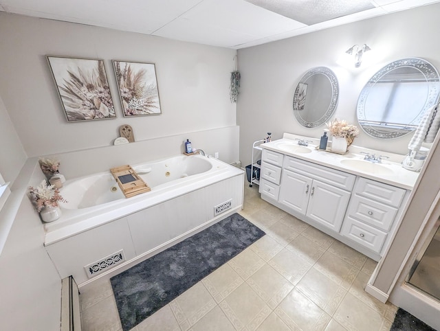 full bath featuring a whirlpool tub, double vanity, and a sink