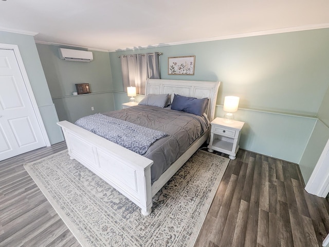 bedroom with dark wood finished floors, crown molding, and a wall mounted AC