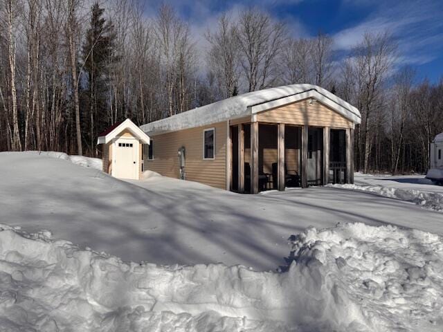 exterior space featuring a storage unit and an outbuilding