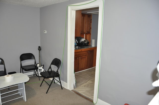 home office featuring baseboards and a textured ceiling