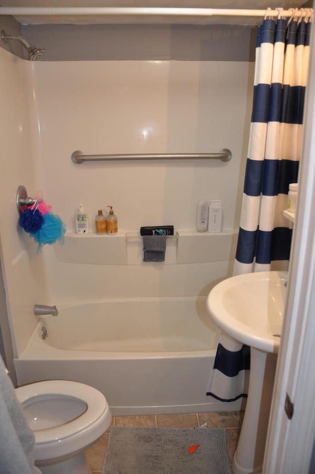 full bathroom with tile patterned flooring, toilet, shower / bath combo, and a sink