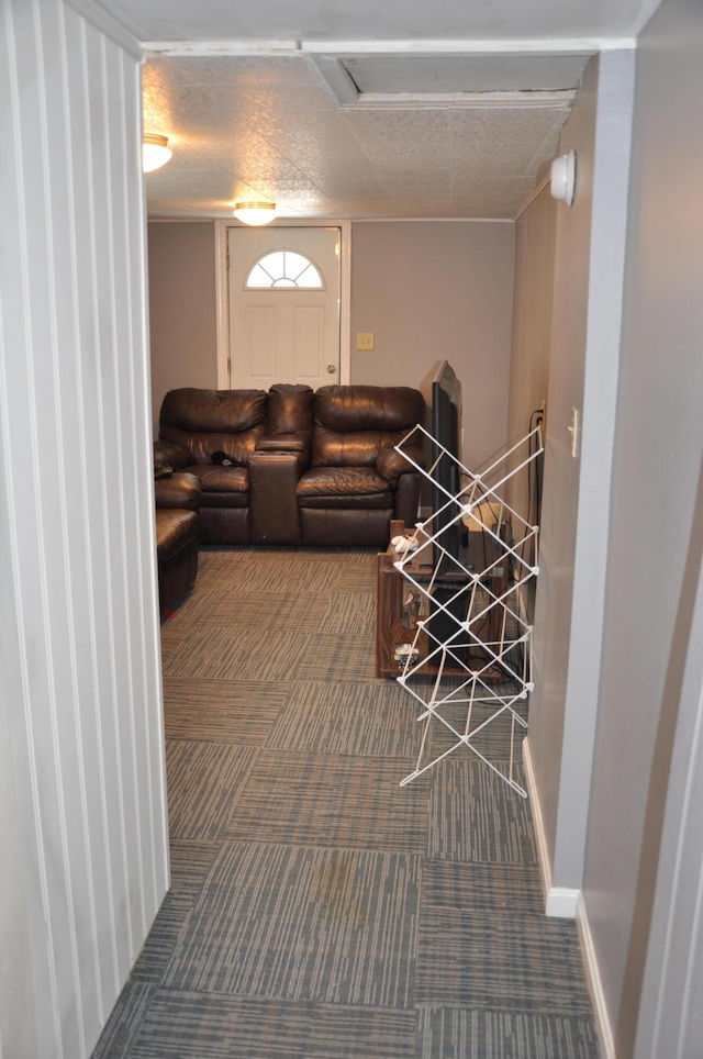 carpeted living room featuring baseboards