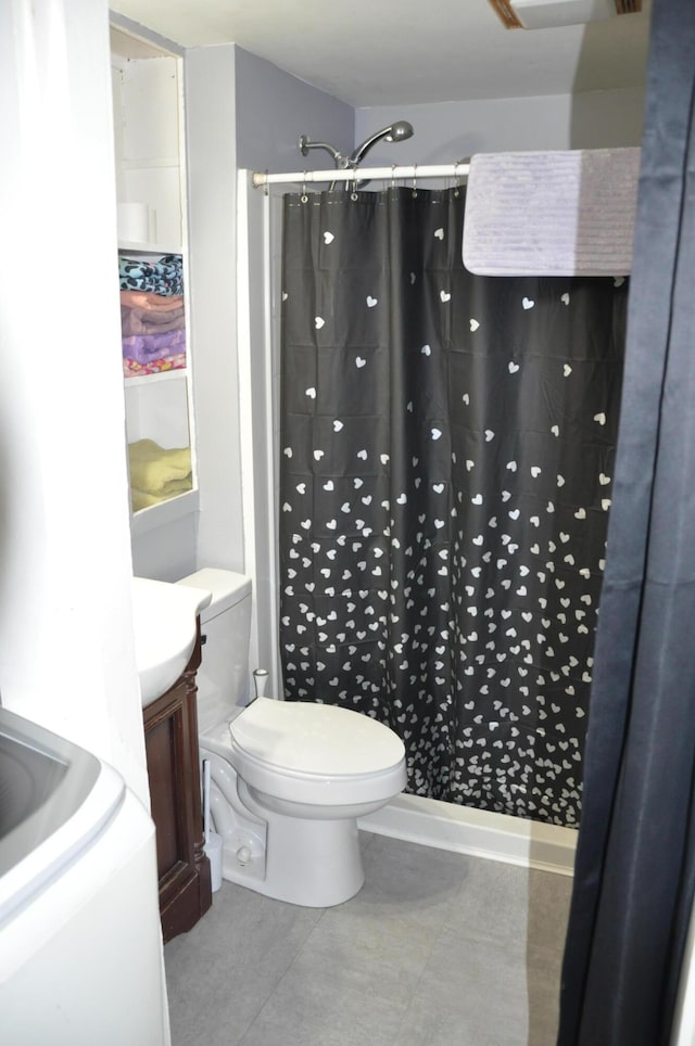 bathroom with curtained shower, tile patterned floors, toilet, and vanity