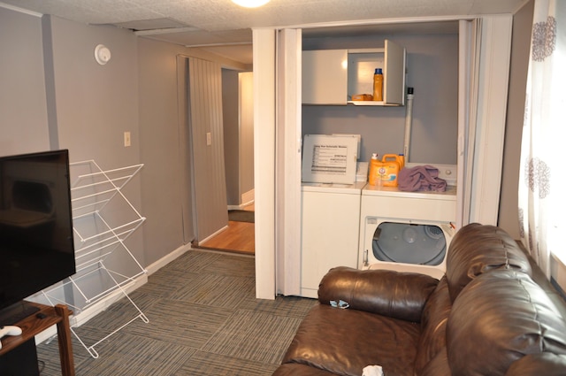 living area featuring washer and dryer, a drop ceiling, baseboards, and carpet floors