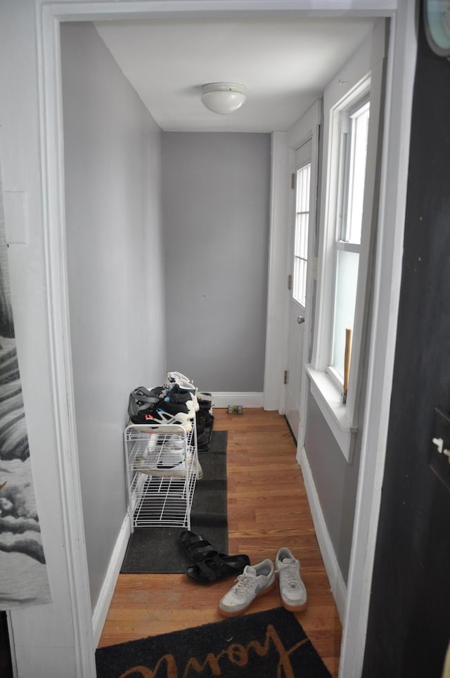 interior space with wood finished floors and baseboards