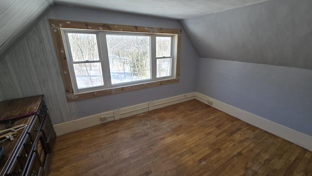 bonus room with vaulted ceiling, baseboards, and wood finished floors