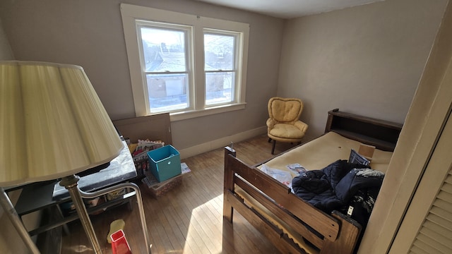 bedroom with baseboards and wood finished floors