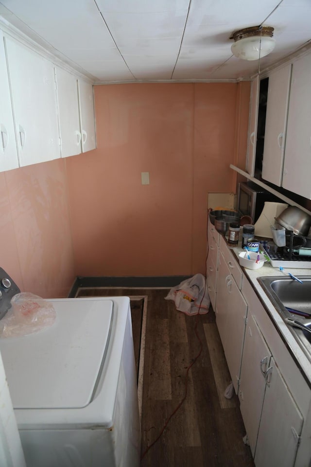 washroom with laundry area, washer / clothes dryer, dark wood-style flooring, and a sink