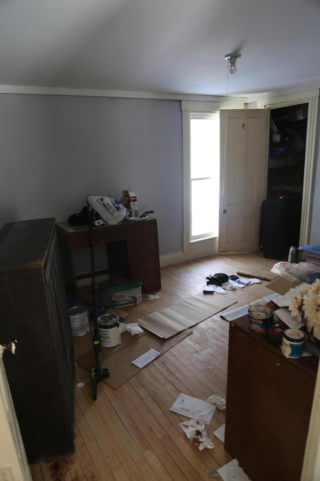 interior space with light wood-style flooring and ornamental molding