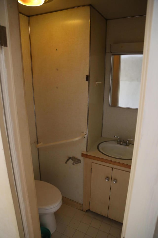 bathroom featuring toilet, vanity, and tile patterned floors