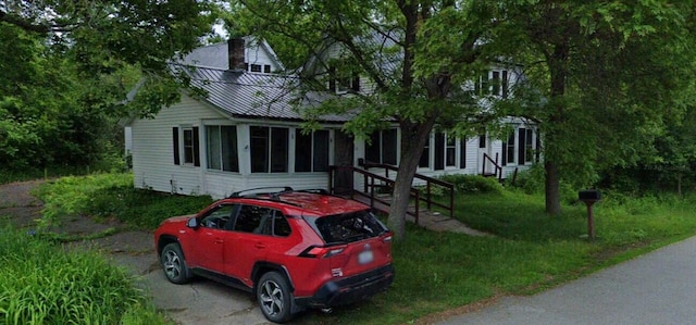 view of front of home with a sunroom