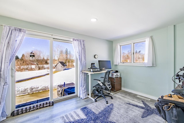 office space featuring baseboards and wood finished floors