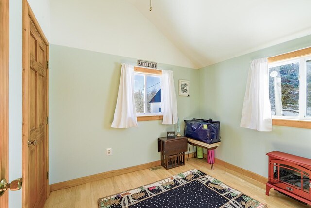 rec room with plenty of natural light, baseboards, vaulted ceiling, and wood finished floors
