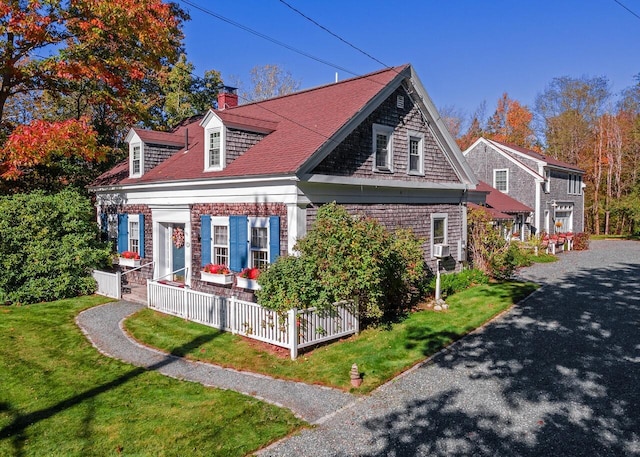 view of side of home featuring a yard, a chimney, cooling unit, and fence